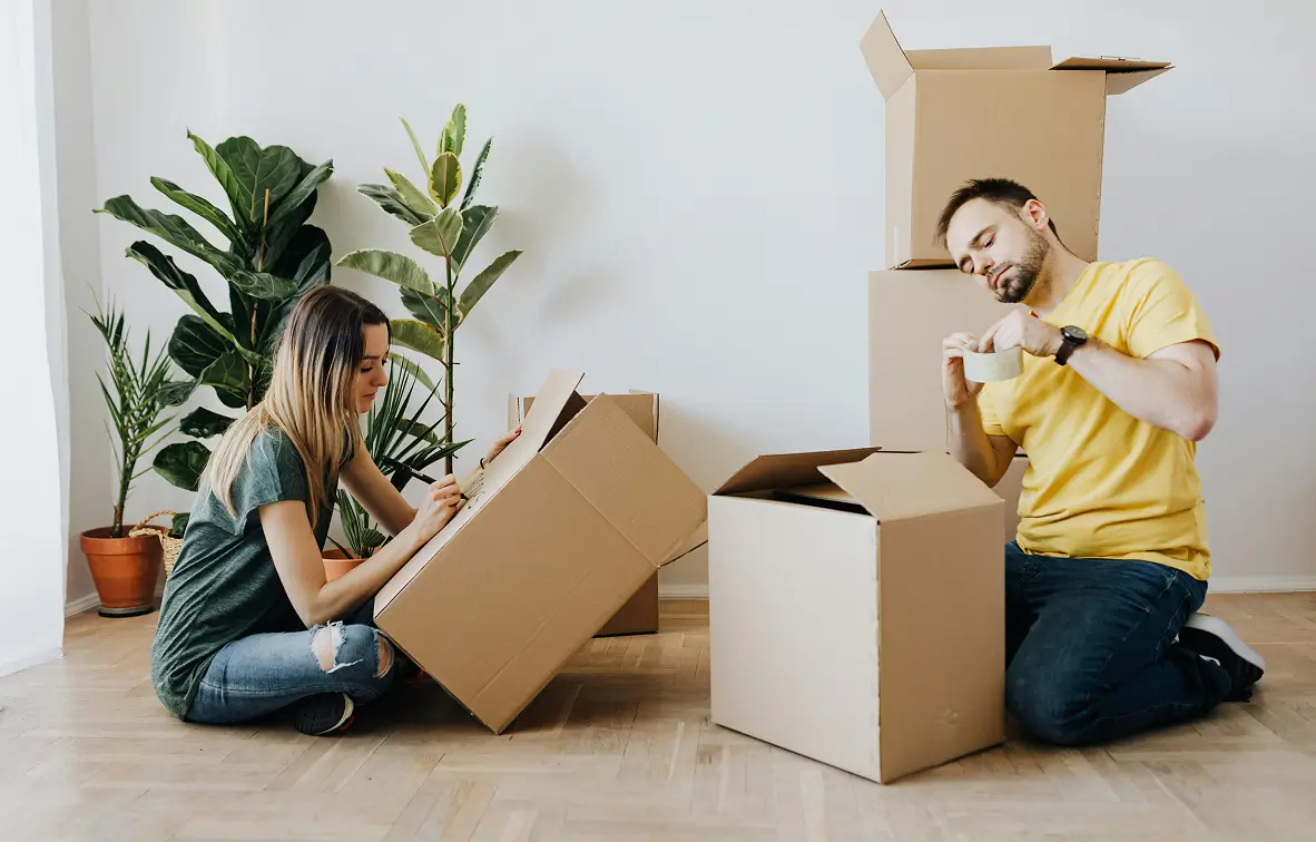 Couple unpacking boxes in their new home